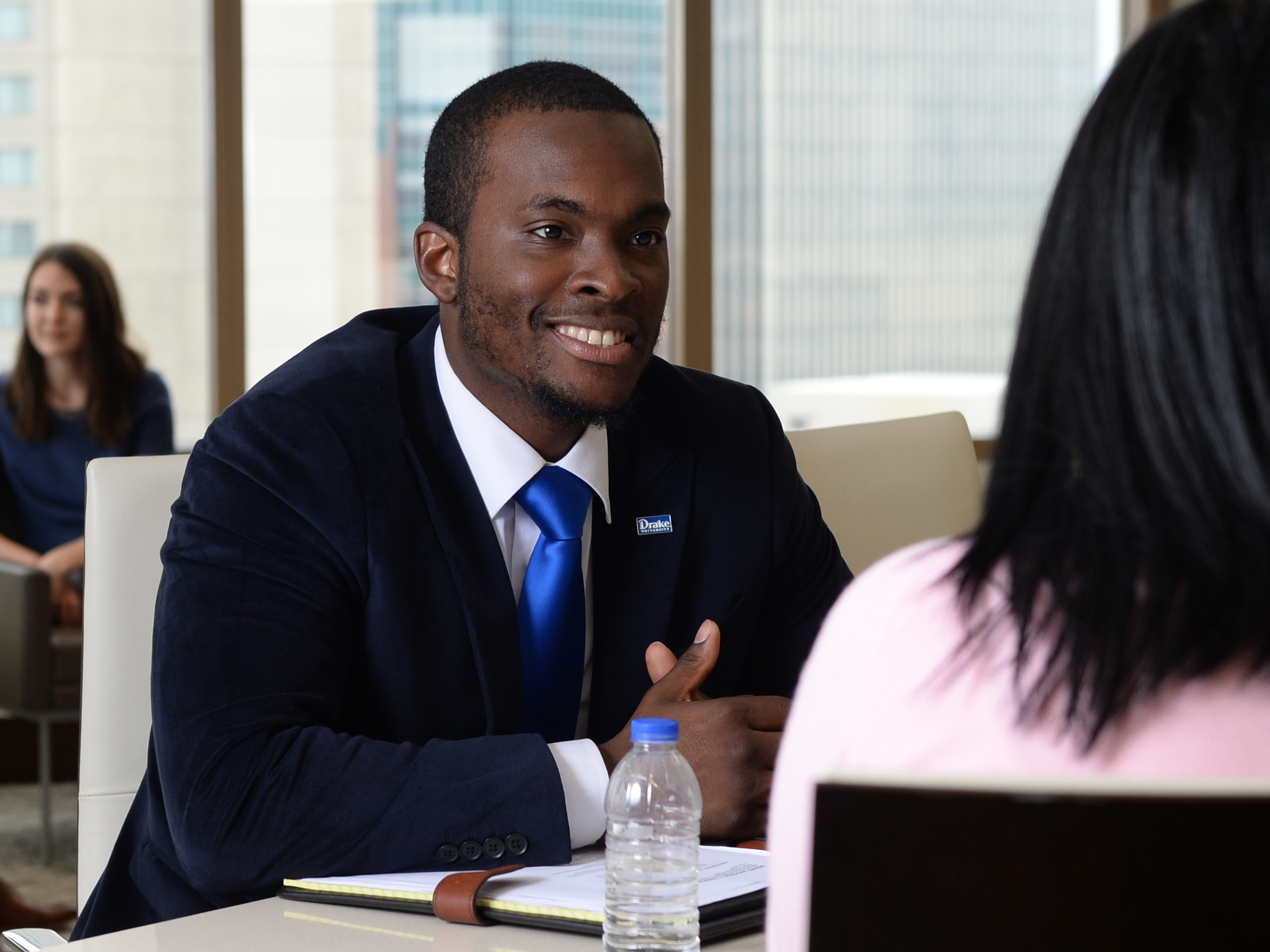 A student in a suit and tie attends an appointment with a career counselor at Drake