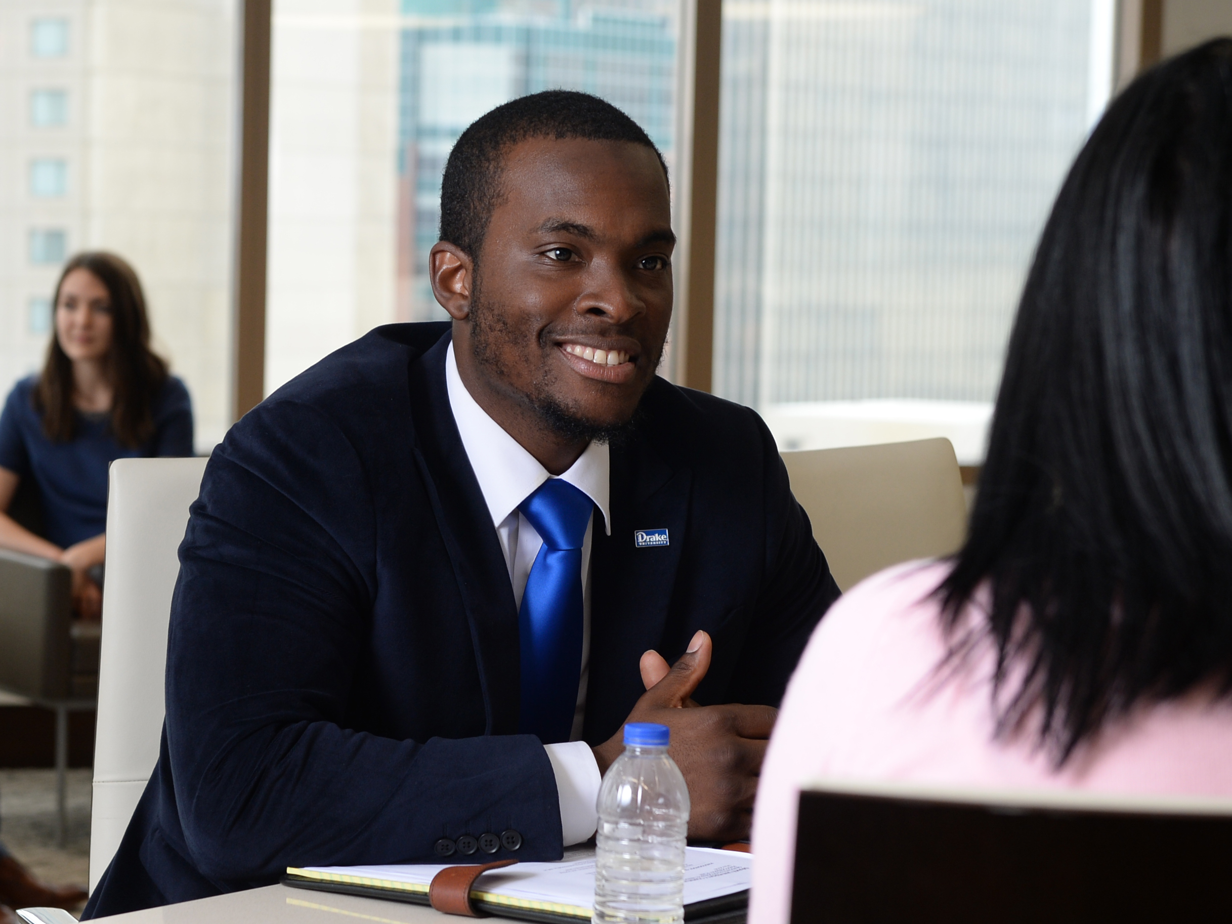 A Drake graduate student in a suit meets with a career center advisor to discuss related job opportunities