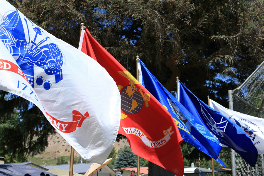 A row of armed forces flags flying outside