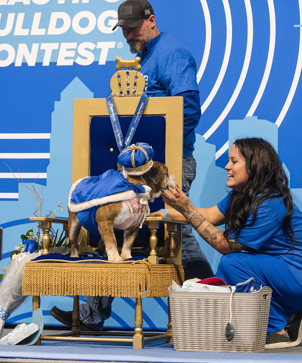 2026, Flora and owners on stage after winning the crown.