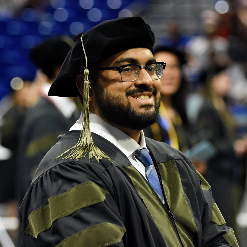  A student from Drake's College of Pharmacy and Health Sciences wears a cap and gown during graduation