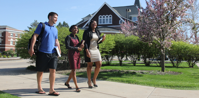 Three law students walking across campus