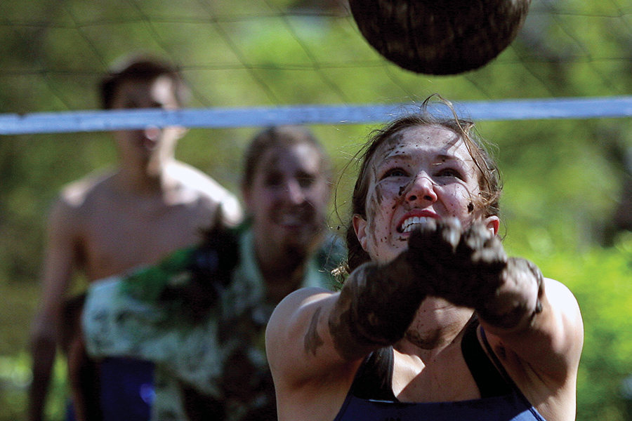 A Drake student prepares to take a shot during an outdoor intramural volleyball game