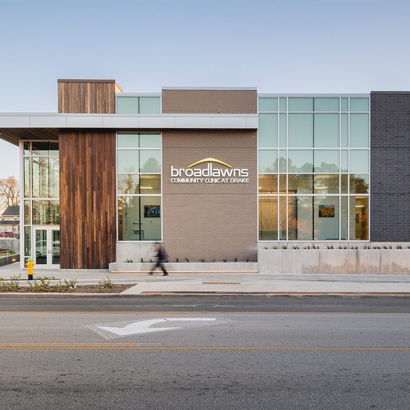 A person walks quickly by the Broadlawns Community Clinic, located on Drake's campus