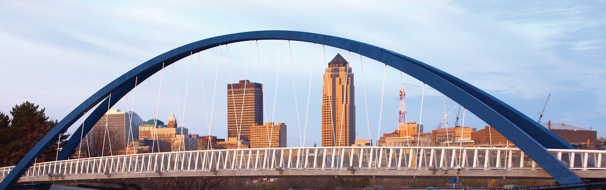 An image of the Des Moines skyline, shot through the Rider Way Pedestrian Bridge