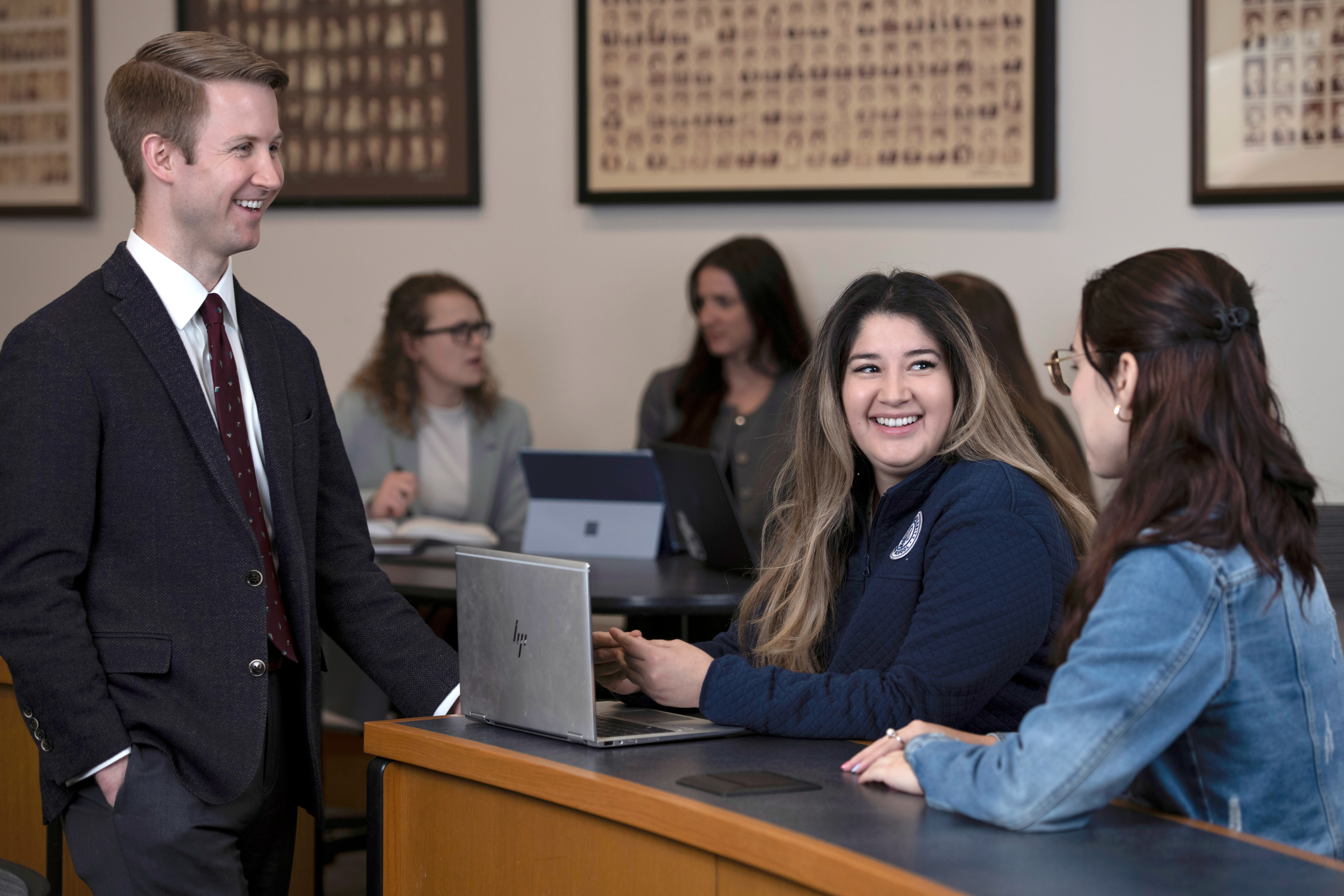 Arts and Sciences students participating in the 3+3 Law program have a conversation in a courtroom