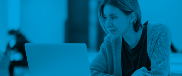 Student Sitting at Desk with Laptop, Blue Overlay